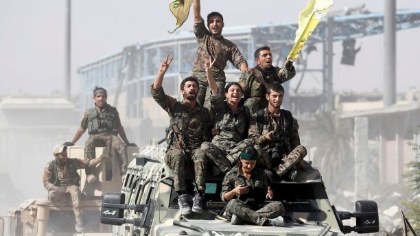 Syrian Democratic Forces (SDF) fighters ride atop military vehicles as they celebrate victory in Raqqa, Syria, October 17, 2017. REUTERS/Erik De Castro TPX IMAGES OF THE DAY - RC18150D4560