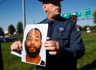 The Latest: Suspect discarded gun, ran when he saw police (Report)