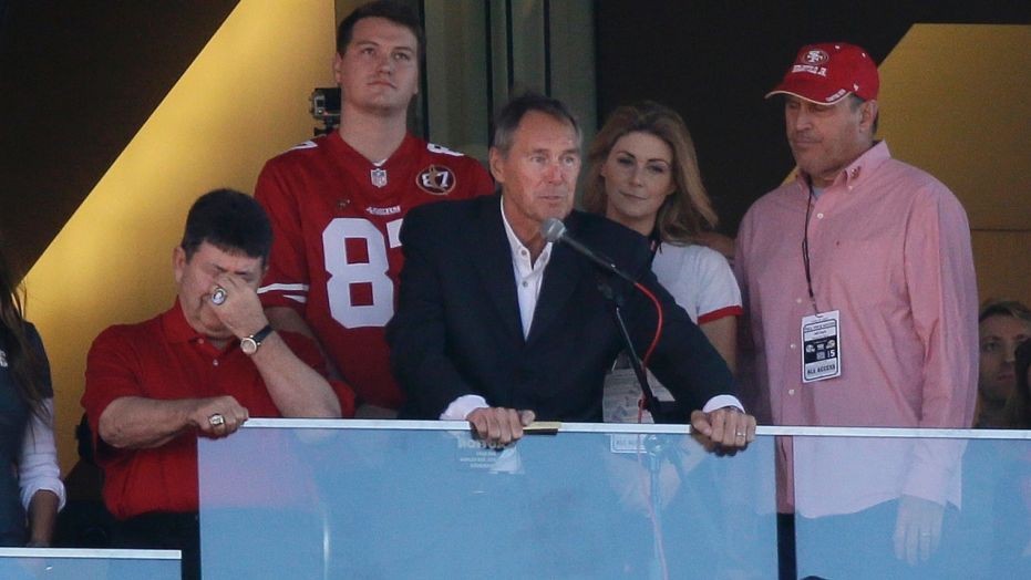 Oct. 22: Dwight Clark, center, speaks next to former San Francisco 49ers owner Edward DeBartolo Jr., left, during halftime of an NFL football game between the 49ers and the Dallas Cowboys in Santa Clara, Calif.