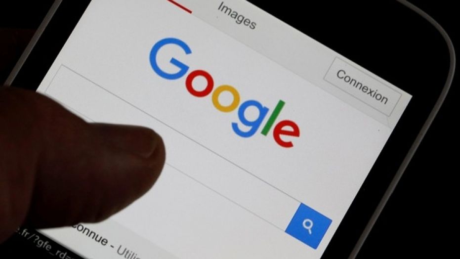 A smartphone user accesses the Google homepage, in a photo illustration taken in Bordeaux, France, Aug. 22, 2016.