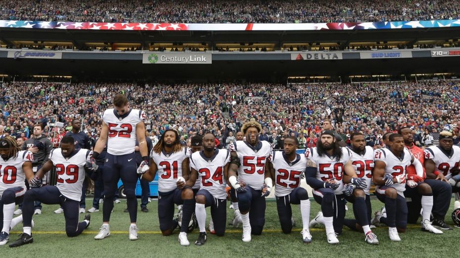 Houston Texans players kneel and stand during the singing of the national anthem before an NFL football game against the Seattle Seahawks, Sunday, Oct. 29, 2017, in Seattle.