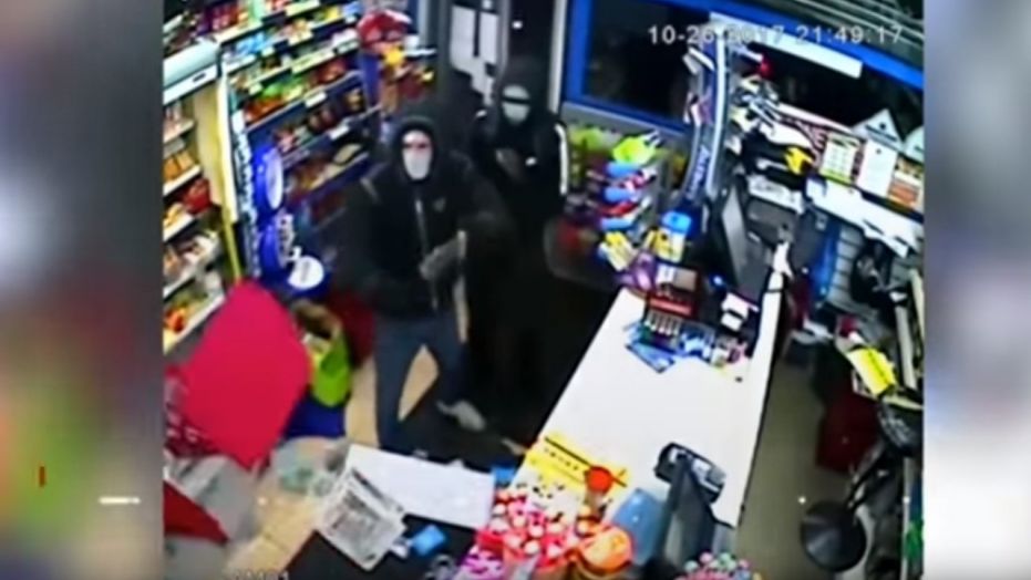 Police in the United Kingdom are looking for two would-be robbers who were chased from a store by an employee who threw what appeared to be alcohol at them.