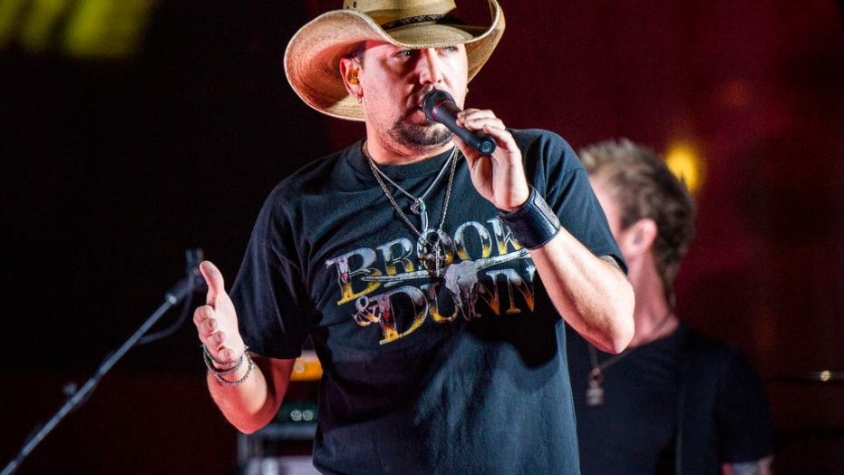 FILE - In this June 7, 2017 file photo Jason Aldean performs during a surprise pop up concert at the Music City Center in Nashville, Tenn. Aldean was the headlining performer when a gunman opened fire at a music festival on the Las Vegas Strip on Sunday, Oct. 1. (Photo by Amy Harris/Invision/AP, File)
