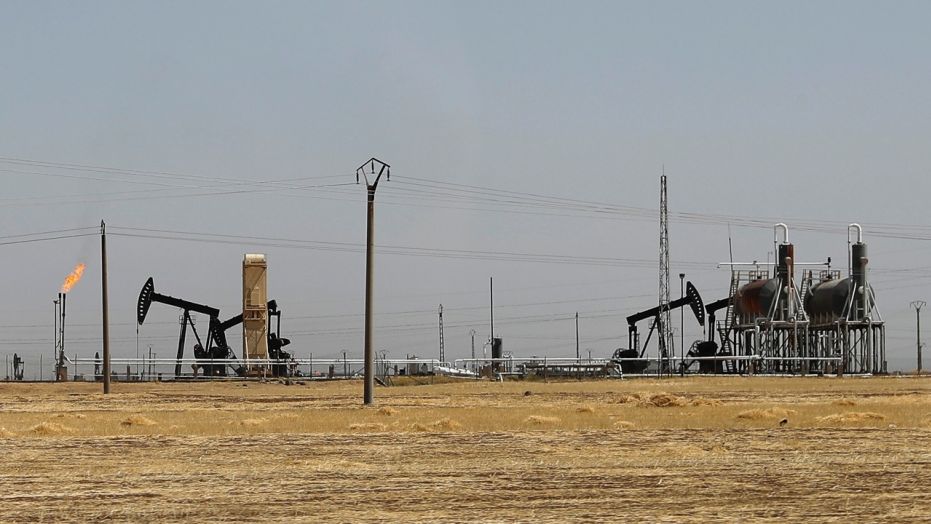 This July 30, 2017 photo, shows an oil field controlled by the Kurdish-led Syrian Democratic Forces, in Rmeilan, Hassakeh province, northeast Syria. 