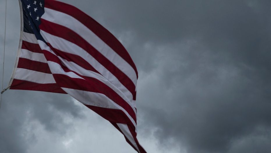 American Flag blowing in the wind of an approaching storm