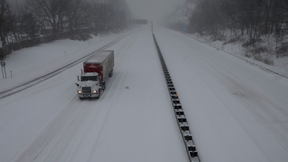 A tractor trailer travels on New York State Thruway covered by snow, near Nyack, a northern suburb of New York City, in March 2017