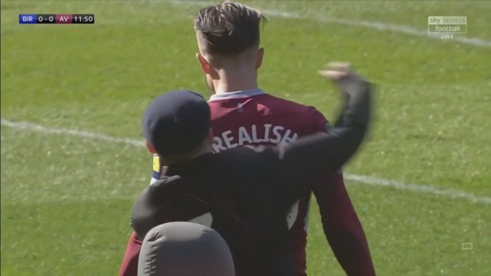 Jack Grealish punched from behind by pitch invader mid-match (Video)